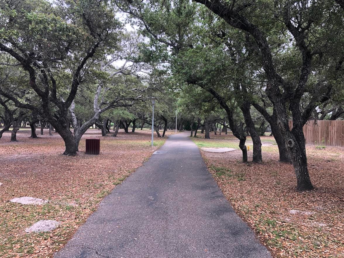 Paved trail through live oak canopy at Memorial Park Rockport Texas
