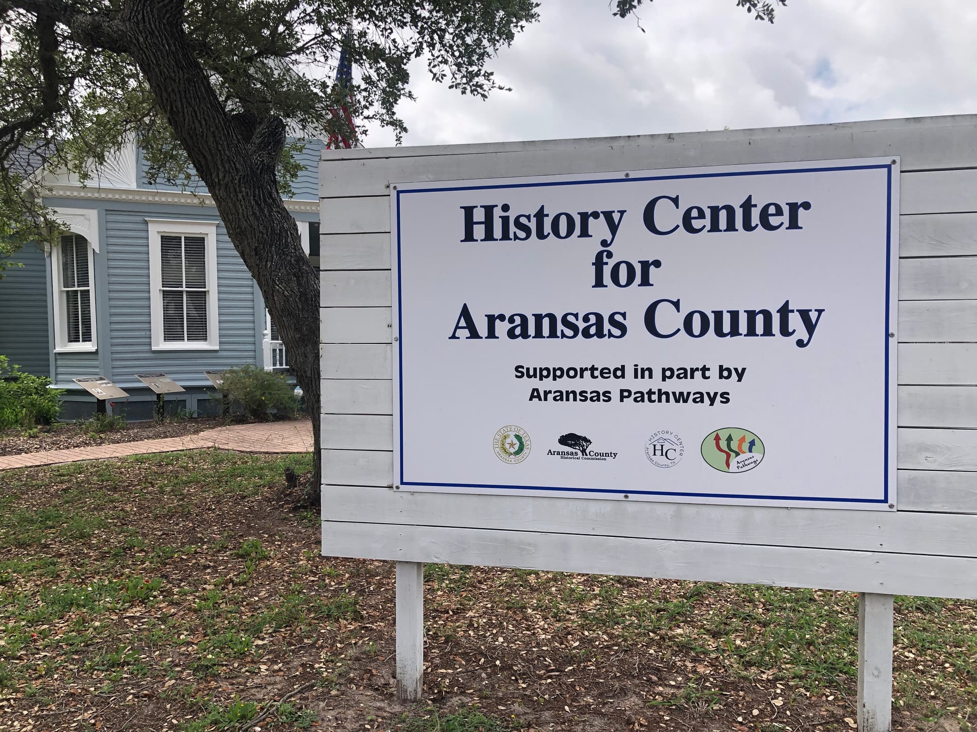 History Center for Aransas County sign under live oak