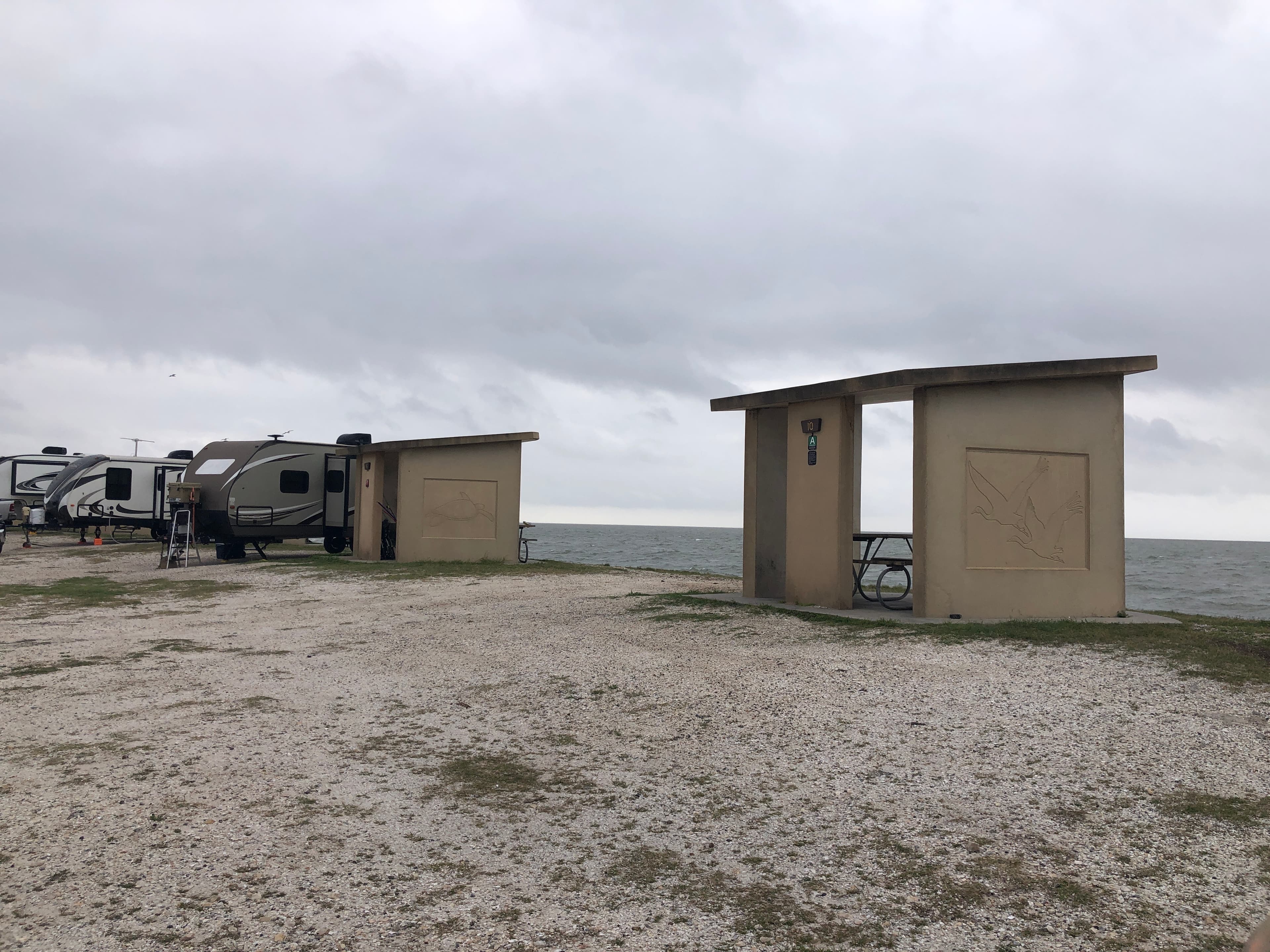 Shell piles staged at Goose Island State Park with Aransas Bay behind — Sink Your Shucks restoration event