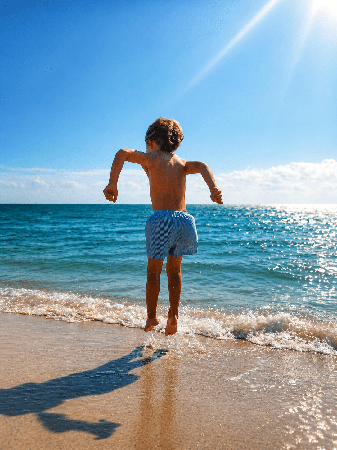 Child jumping in the surf at Rockport Beach Park