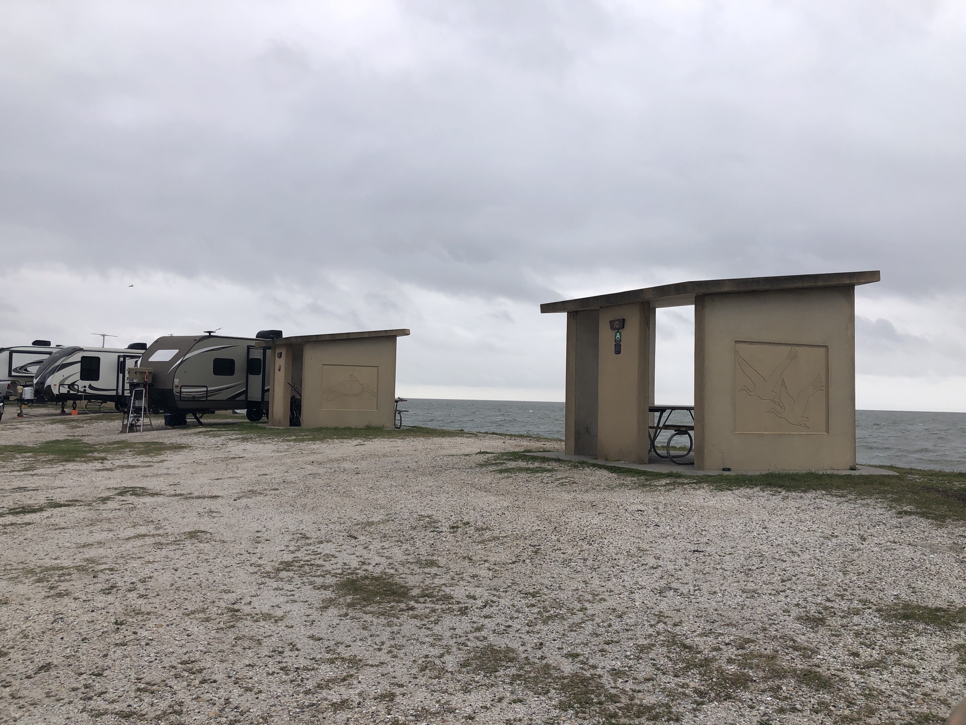 Shell piles staged at Goose Island State Park with Aransas Bay behind — Sink Your Shucks restoration event