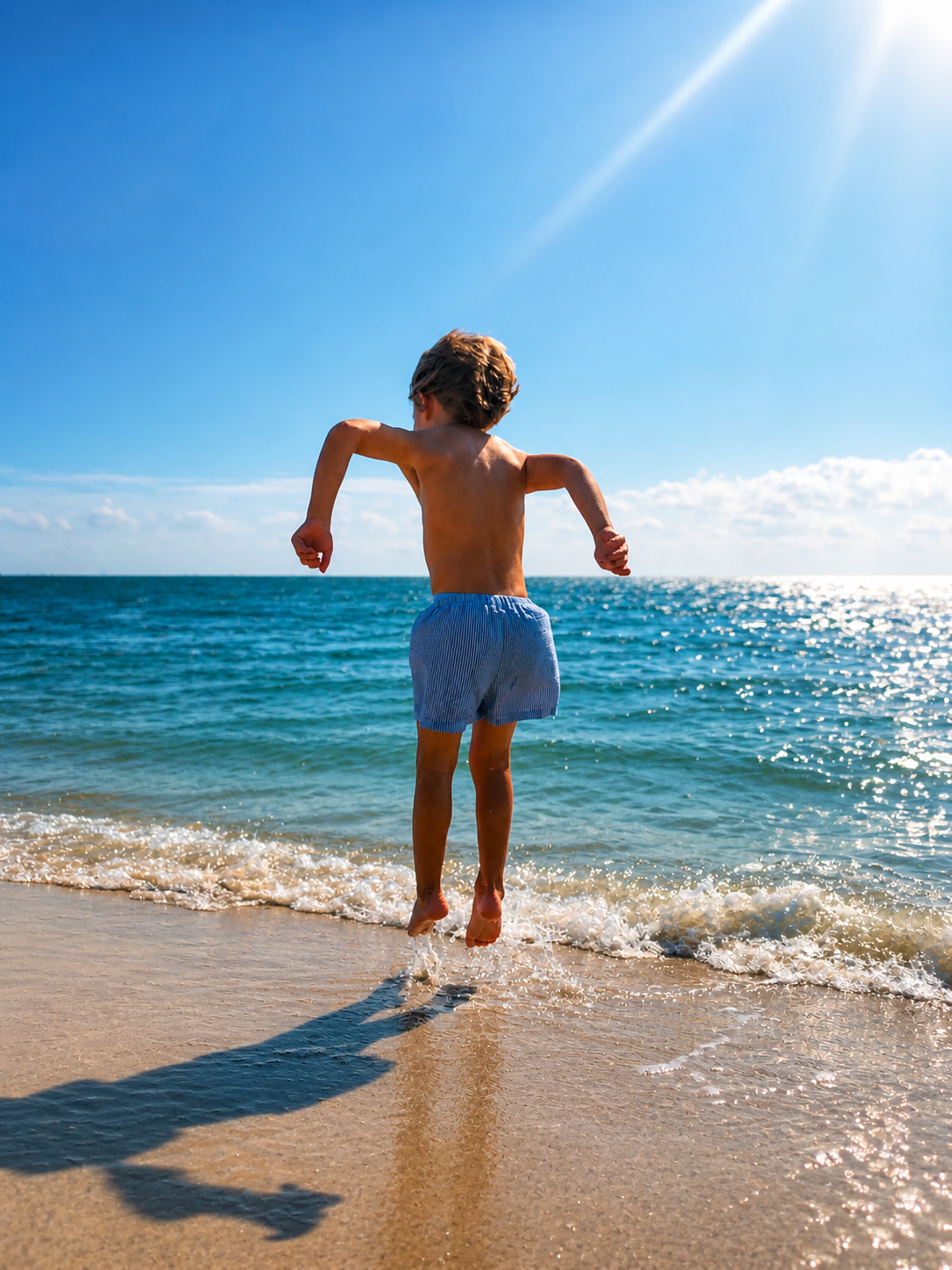 Child jumping in the surf at Rockport Beach Park
